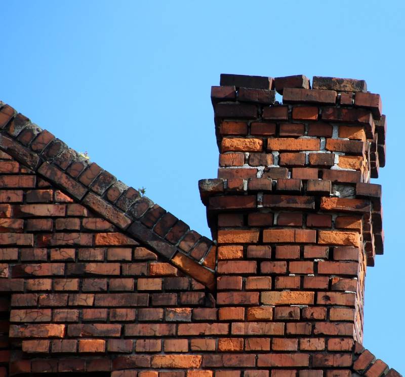 Signs Your Farmington Hills Home Needs a Chimney Inspection Damaged chimney on an Farmington Hills home showing cracks and missing mortar